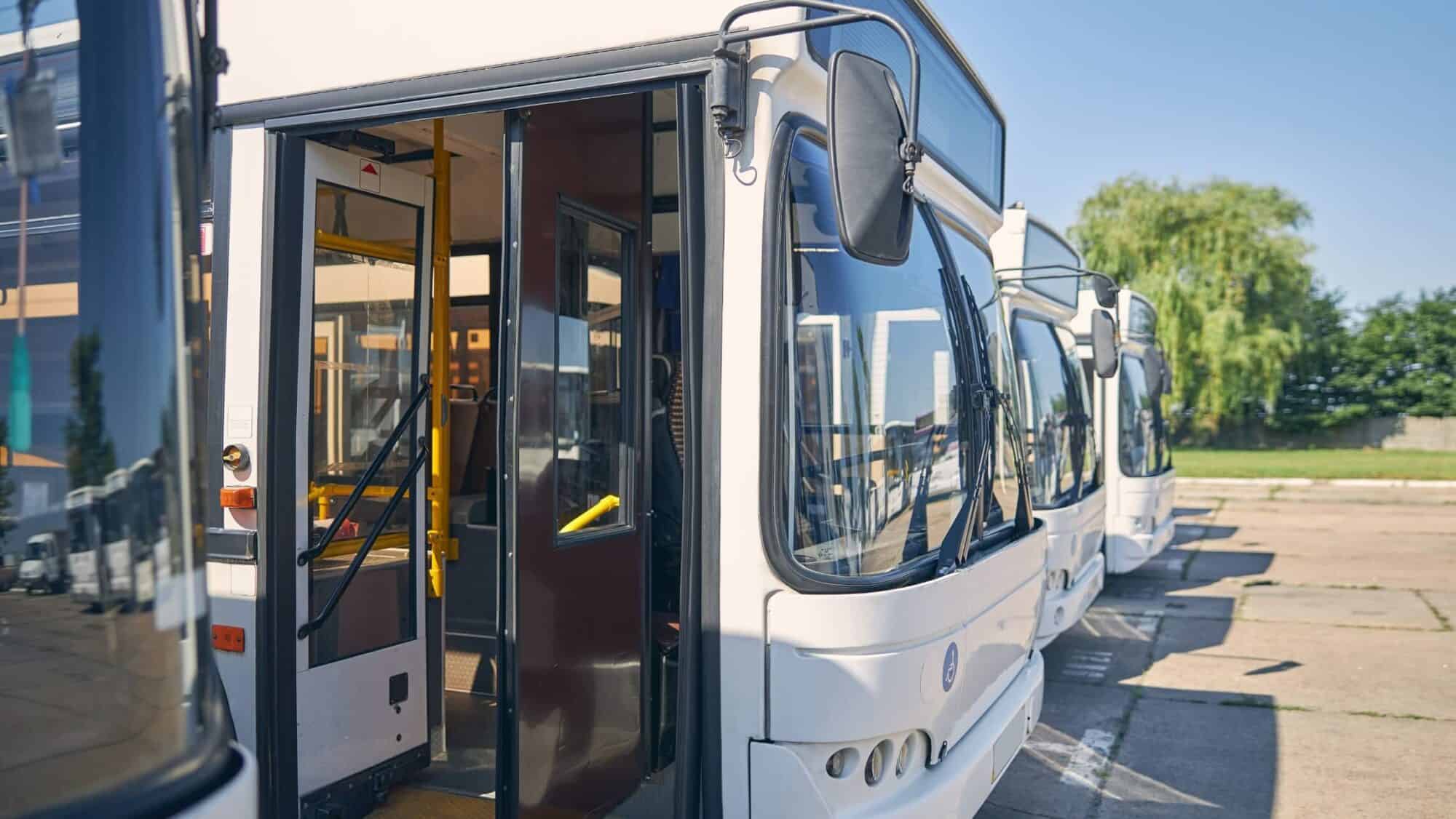 Close-up of white bus with open doors for public transport connectivity in mobility applications