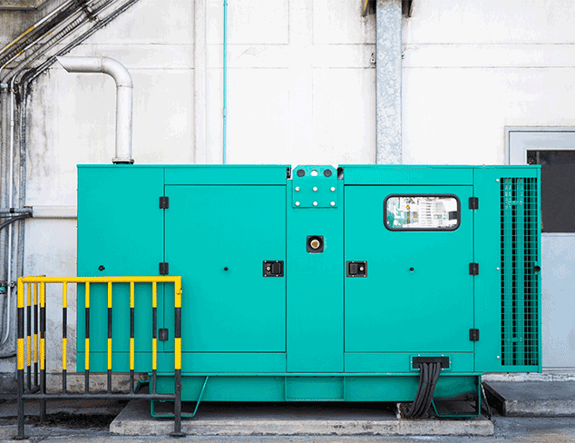 Industrial generator monitored by predictive maintenance sensors showing real-time data on a display