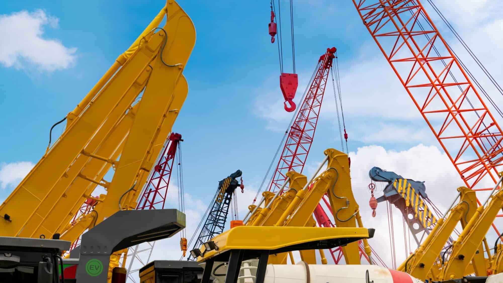 Crawler crane against a blue sky, symbolizing IoT-connected engineering vehicles in mobility solutions for construction