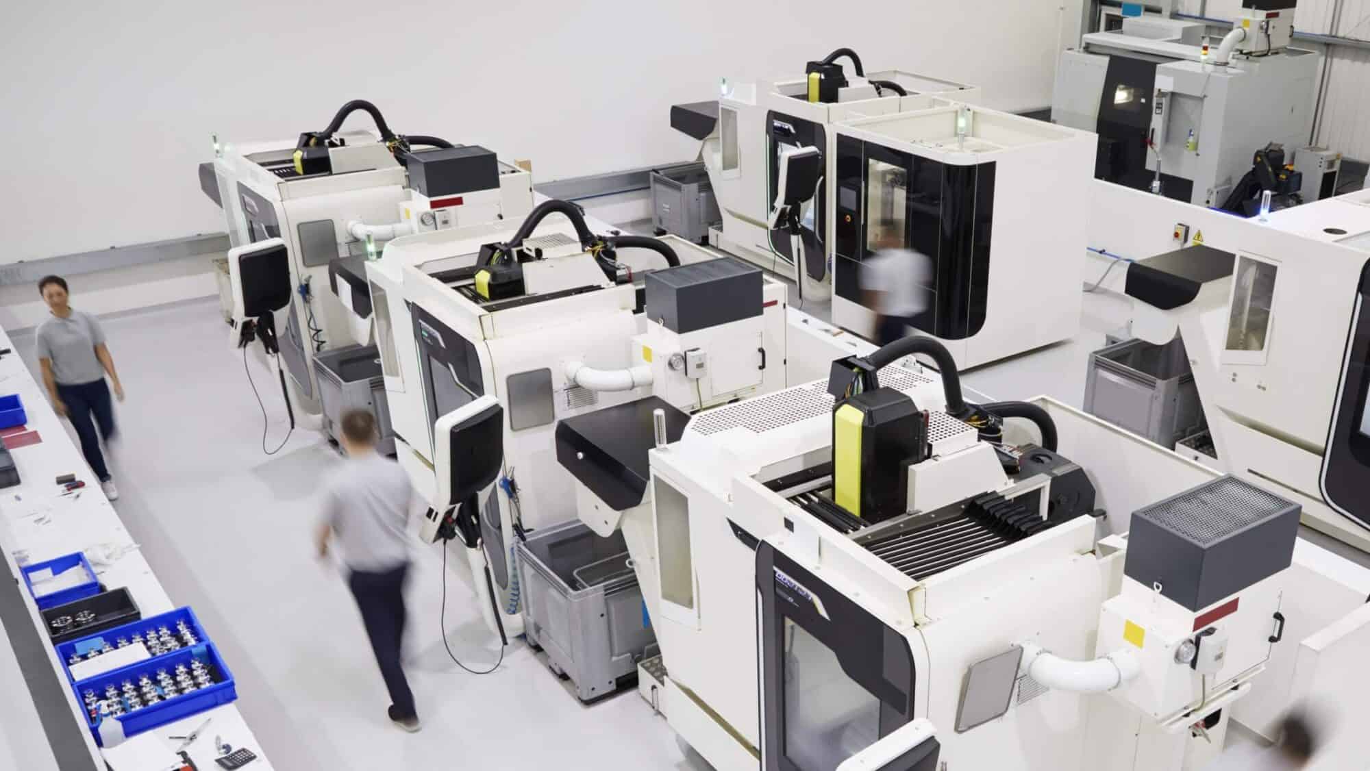 Workers monitoring automated machinery in Digital Factory IoT solution
